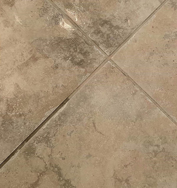 clean and dirty tile grout comparison after partial cleaning
