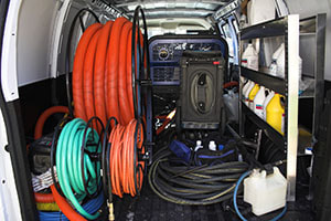 rear of van showing carpet and tile and grout cleaning equipment