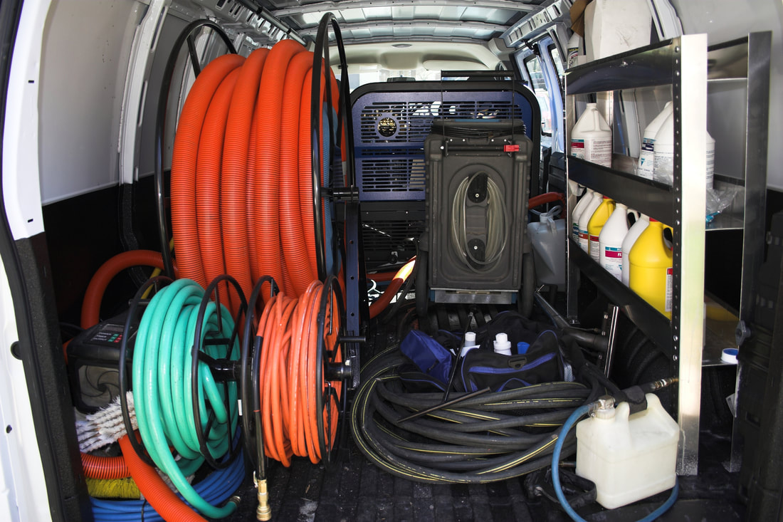 inside of van showing carpet and tile grout cleaning equipment
